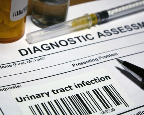 Paper that reads "Diagnostic assessment" and "Diagnosis: Urinary Tract Infection" appears next to a syringe and a pill canister.