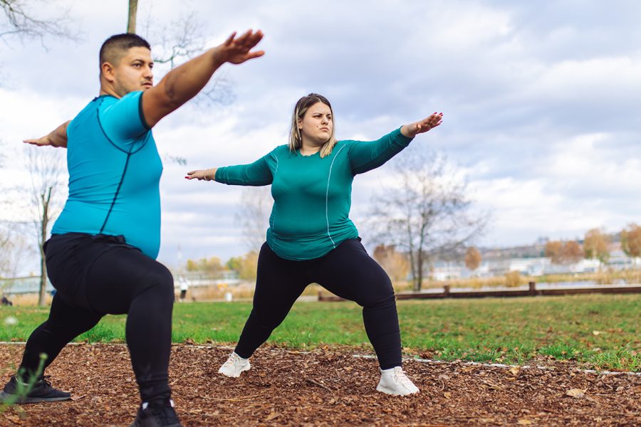 Two people exercising outside